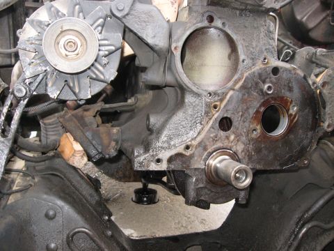 1981 Ford Bronco - Front of an engine with the timing cover exposed and the water pump removed, showing the bare crankshaft snout, the open front seal bore an…