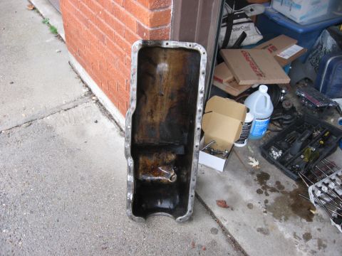 1981 Ford Bronco - Used a grinder to grind the ridges from around the bolt holes off the oil pan. Not too difficult.