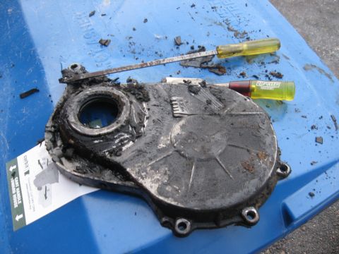 1981 Ford Bronco - Cleaning years of buildup off of the timing cover before installing the new seals.