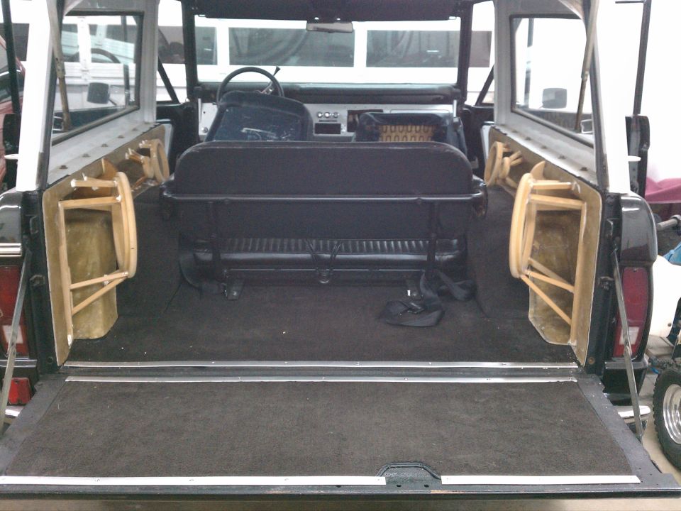 Interior of Ford Bronco viewed from open rear tailgate showing seats and dash
