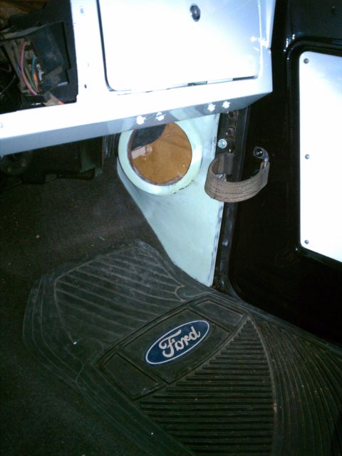 1975 Ford Bronco - Interior view of a vehicle, a Ford logo floor mat and exposed wiring.