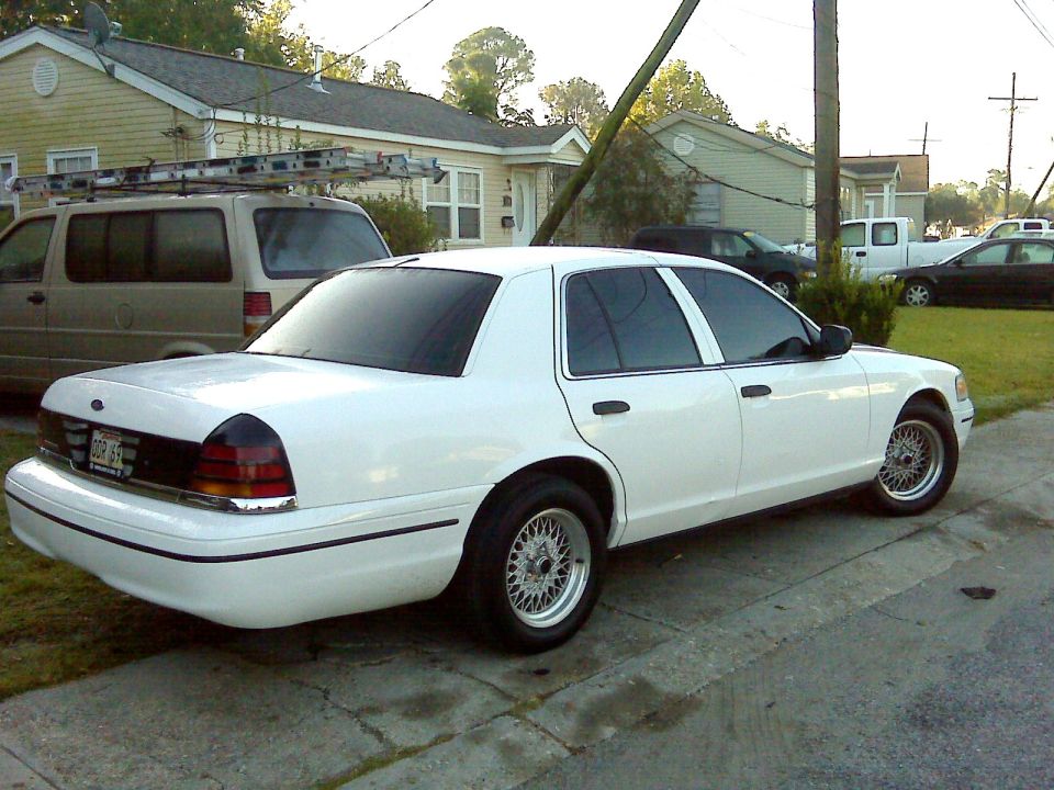 White 2005 Ford Crown Victoria parked on a residential street, side view