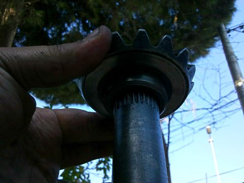 1998 Ford Crown Victoria - A close-up view of a gear and splined shaft, likely a differential component, is held for inspection.