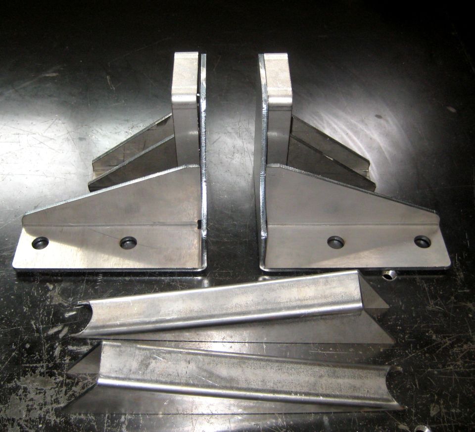 Two metal brackets with mounting holes and several pieces of metal tubing
