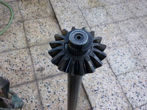 1998 Ford Crown Victoria - A close-up view of a ring gear and pinion shaft, likely for a vehicle's differential.