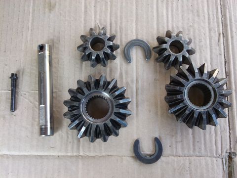 1998 Ford Crown Victoria - Differential gears and related parts laid out on a surface.