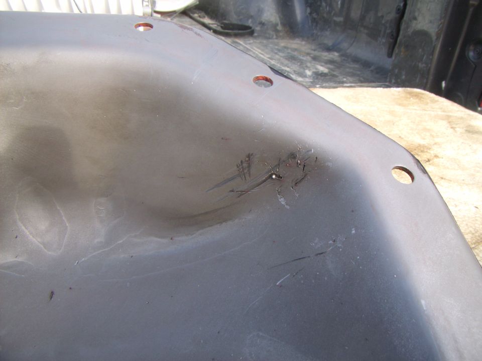 Close-up of a black truck bed liner with some scratches and scuff marks