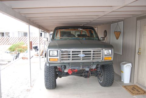 1982 Ford Bronco - Front view of a green Ford truck, possibly from the early 1980s, modified with a roll cage and off-road tires.