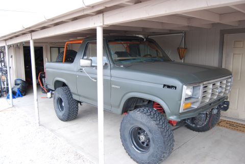 1982 Ford Bronco - This modified Ford Bronco features large off-road tires and a roll cage.