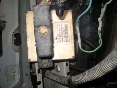 1996 Ford Bronco - Close-up of an anti-lock brake controller mounted within a vehicle's engine bay.