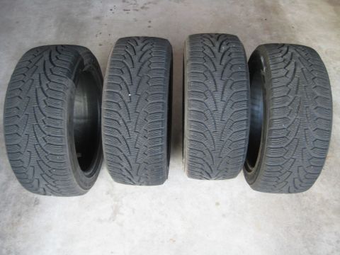1993 Ford Probe - Set of four winter tires displayed on a concrete floor.