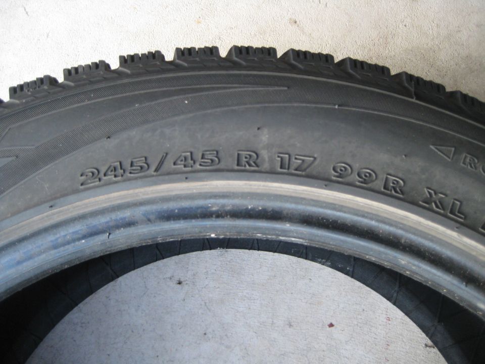 Close-up of a tire with size 245/45 R 17 99R XL printed on it