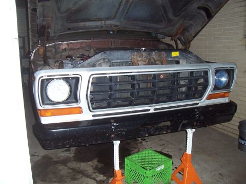 1979 Ford Bronco - The front view of a vehicle's grille and headlights is visible, suggesting it may be in a repair shop or garage.