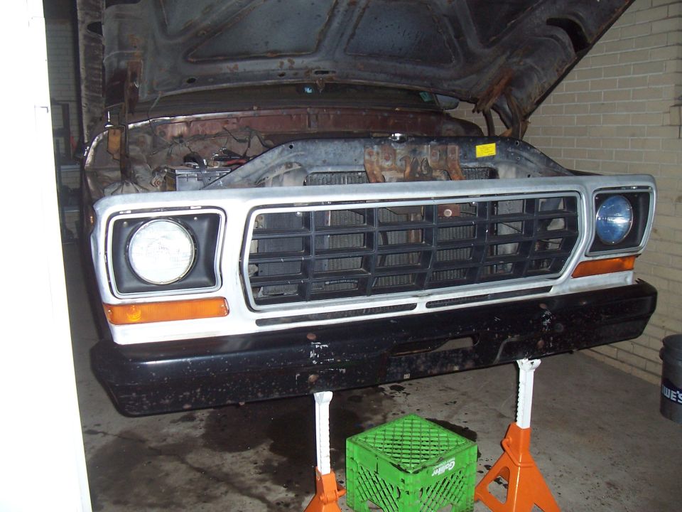 Front grille and headlights of a vehicle, possibly undergoing maintenance