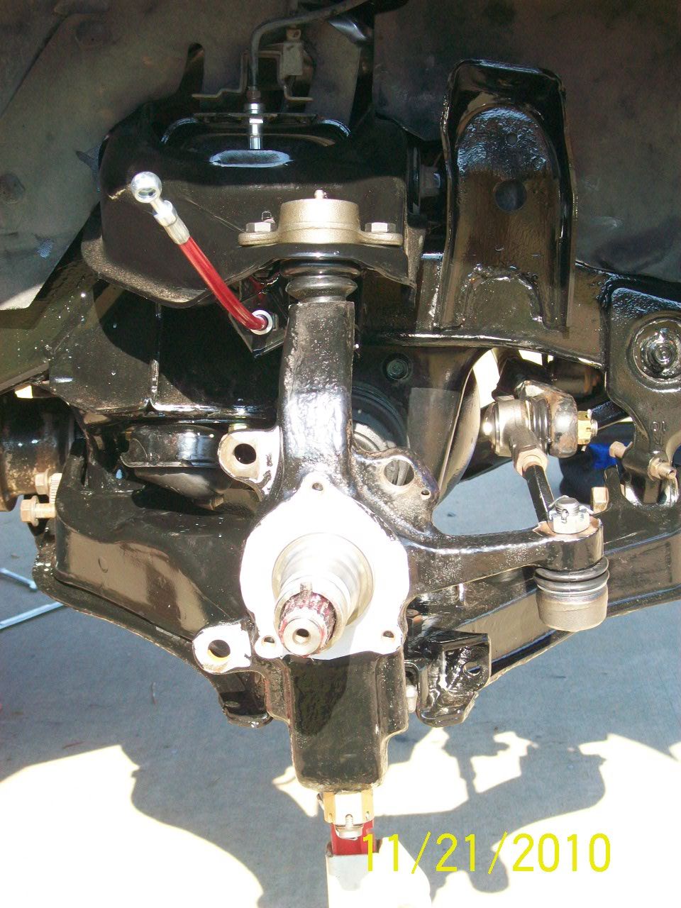 close-up of vehicle's front suspension parts, painted black
