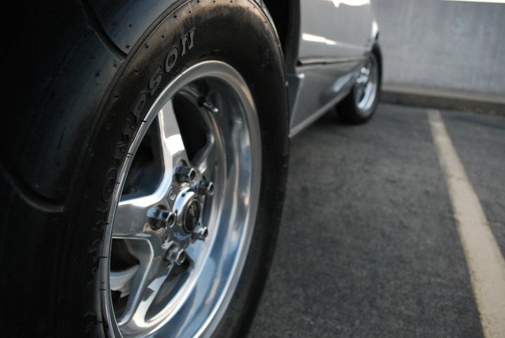 Polished drag wheel with Mickey Thompson tire on a silver car