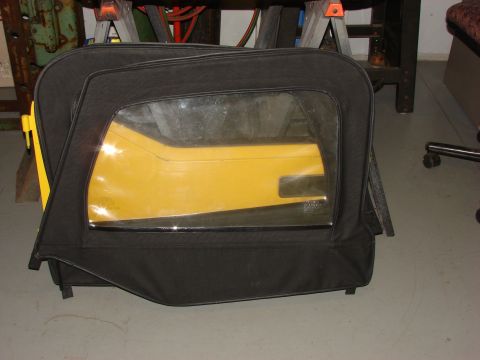 1993 Jeep Wrangler - A black Jeep soft top door with a yellow panel is shown indoors.