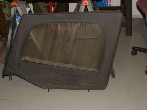 1993 Jeep Wrangler - A single black soft top door for a Jeep YJ is shown, a clear plastic window.