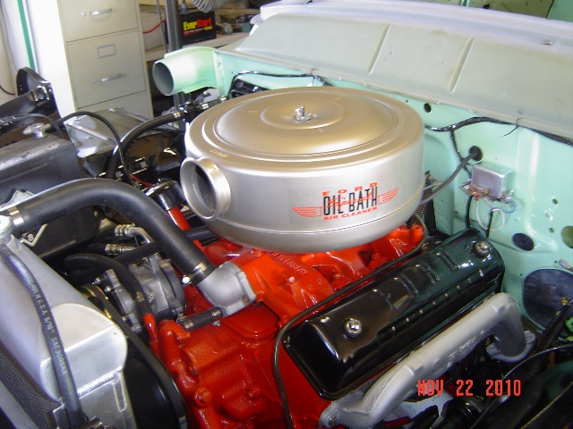 Red Ford V8 engine with silver Ford Oil Bath air cleaner in mint green engine bay