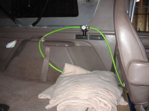 1995 Ford Bronco - front the 4 gal tank under the truck, the green 3/8ths hose feeds up through the floor and into a regulator which I've mounted out of the w…