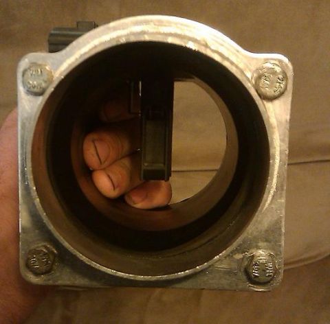 2000 Mercury Grand Marquis - Mass air flow sensor being held by a hand.