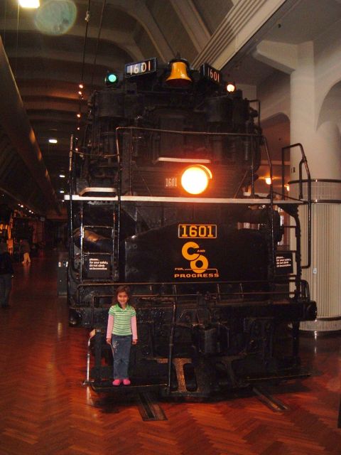 1971 Ford Ranchero - A girl stands before a large black steam locomotive numbered 1601.
