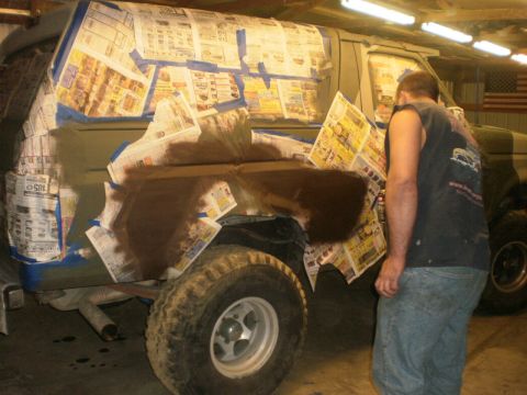 1995 Ford Bronco - Ford Bronco undergoing preparation for a new paint job in a garage.
