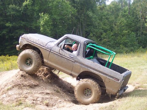 1979 Ford Bronco - A heavily modified 1978 Ford Bronco navigates an off-road obstacle course with a driver and passenger inside.