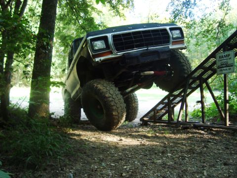 1979 Ford Bronco - This lifted 1979 Ford Bronco is captured mid-climb on a metal ramp, its off-road capabilities.