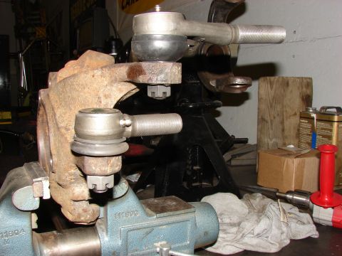 1993 Jeep Wrangler - Close-up of steering linkage components, including a knuckle and tie rod ends, secured in a vise.