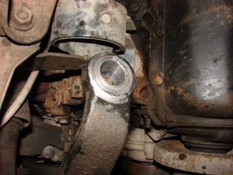 1993 Jeep Wrangler - Detail of a worn vehicle suspension component, showing rust and grime on metal parts.