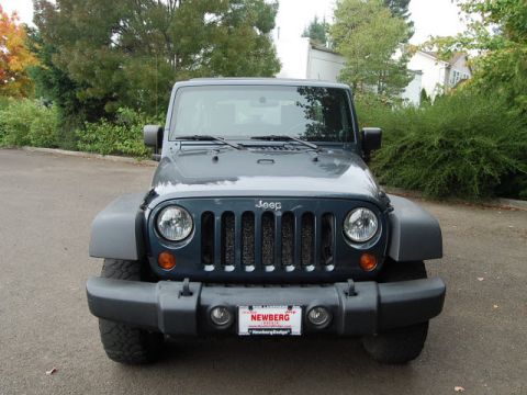 2005 Jeep Wrangler - A dark blue Jeep Wrangler is shown from the front, its signature grille and a license plate from Newberg.
