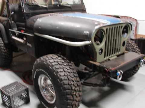 1993 Jeep Wrangler - Front view of a 1993 Jeep YJ undergoing modifications, showing its grille and bumper.
