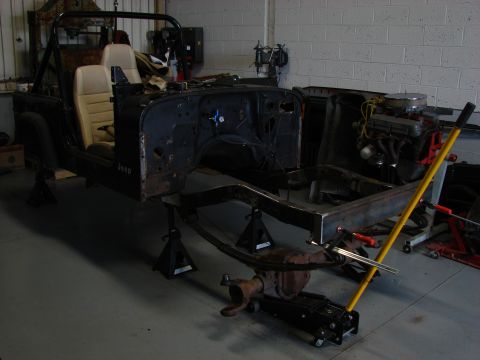 1993 Jeep Wrangler - This Jeep is undergoing restoration, with its body and chassis separated and supported by jack stands.