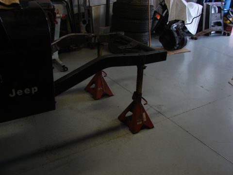 1993 Jeep Wrangler - Jeep frame section is elevated on jack stands for maintenance or repair.