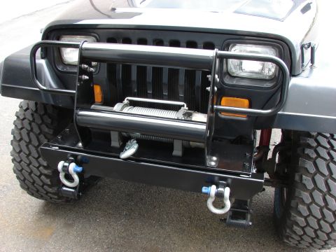 1993 Jeep Wrangler - Front view of a 1993 Jeep YJ an aftermarket bumper with a winch and tow hooks.