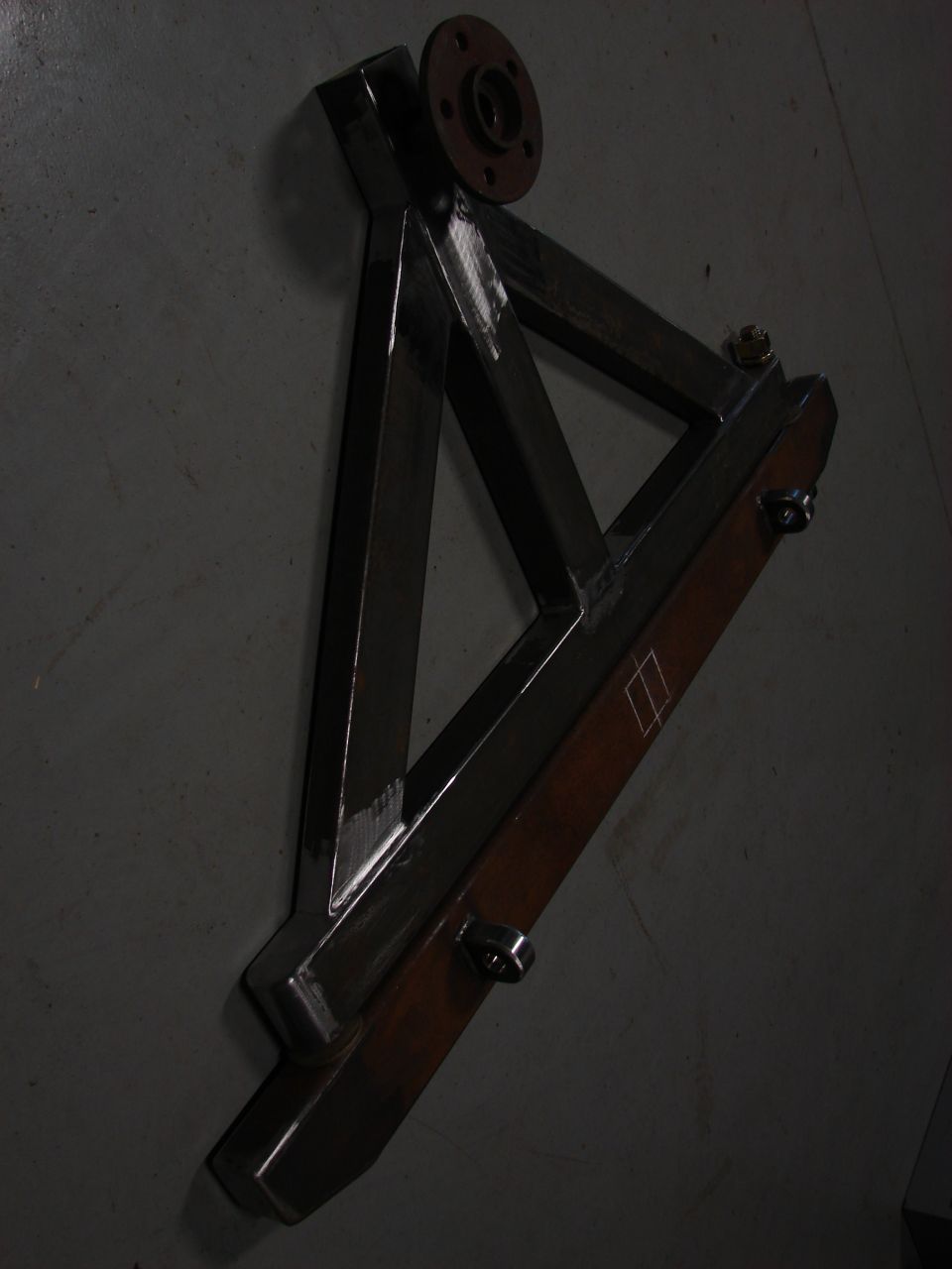 custom metal bracket with a circular flange and some bolts