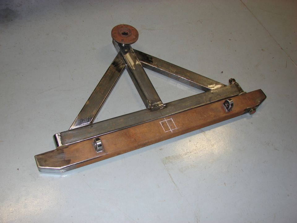 Custom metal spare tire carrier with a wooden base and metal frame
