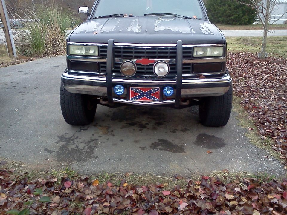 Black 1991 Chevrolet C/K Pickup front view with a brush guard and Confederate flag license plate frame