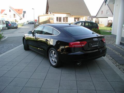 2010 Audi A4 - Rear view of a black Audi A5 Sportback parked on a tiled driveway. The license plate area has a Supermotors.net watermark.