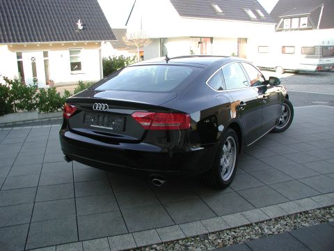 2010 Audi A4 - Black Audi sedan parked in front of a house and a camper.