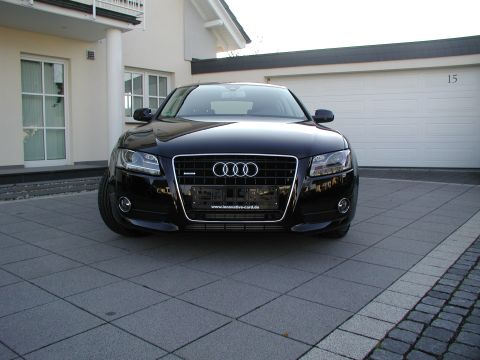 2010 Audi A4 - Front view of a black Audi sedan parked in front of a garage.