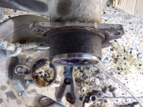 1998 Ford Crown Victoria - This photo shows a close-up of a vehicle's axle assembly, focusing on a greased wheel bearing, not a 1998 Ford Crown Victoria.