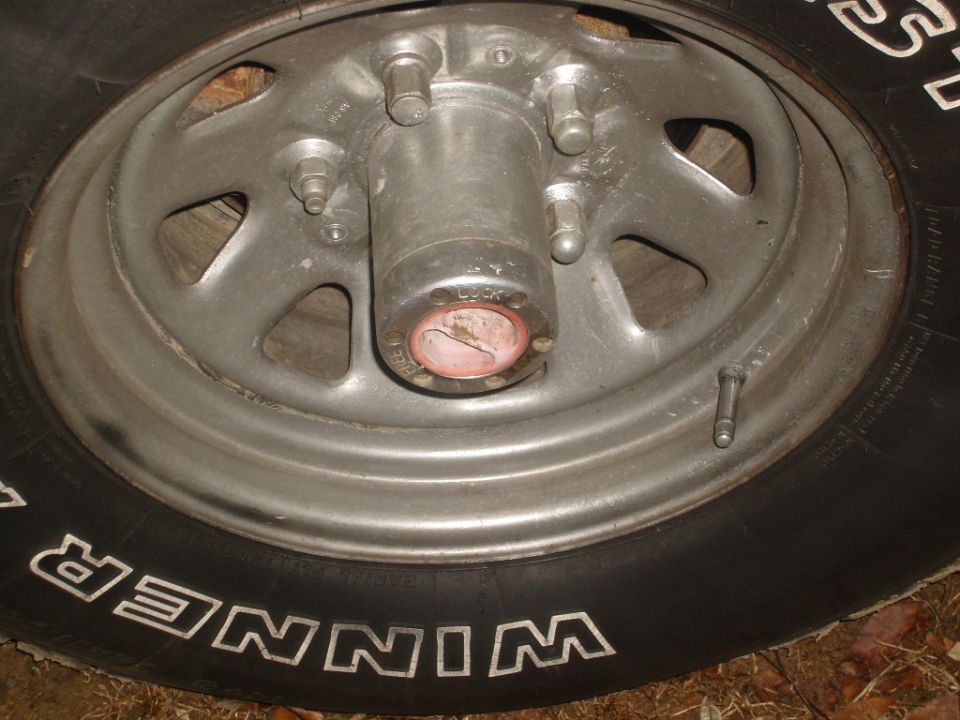 Wheel with red and silver hubcap, tire reads WINNER