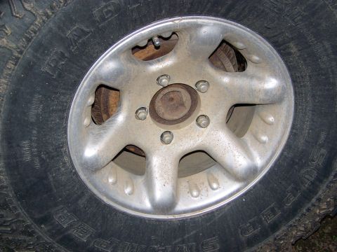 1992 Jeep YJ - A close-up shot focuses on a vehicle's wheel and tire, showing the tread and rim details.