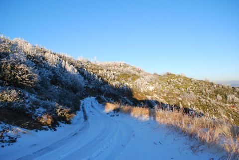 1996 Ford Bronco - A winter scene with a snow-covered road winding up a frosted mountainside.