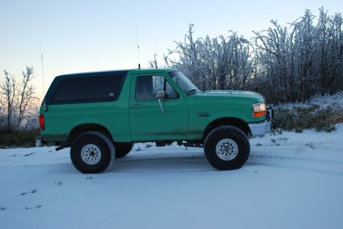 1996 Ford Bronco - This 1996 Ford Bronco is seen in a snowy landscape with frosted trees in the background.