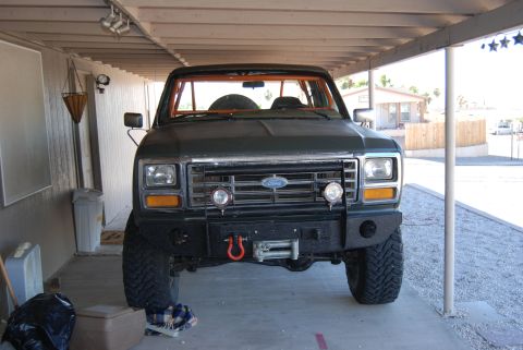 1982 Ford Bronco - This Ford Bronco has an aftermarket bumper, winch, and an orange roll cage visible.