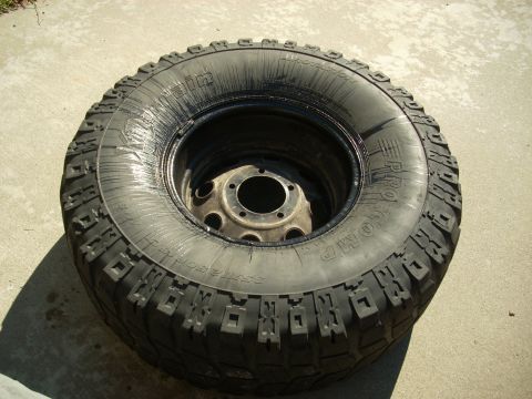 1989 Ford Bronco - A close-up view of a BFGoodrich Mud-Terrain T/A tire on a rim.