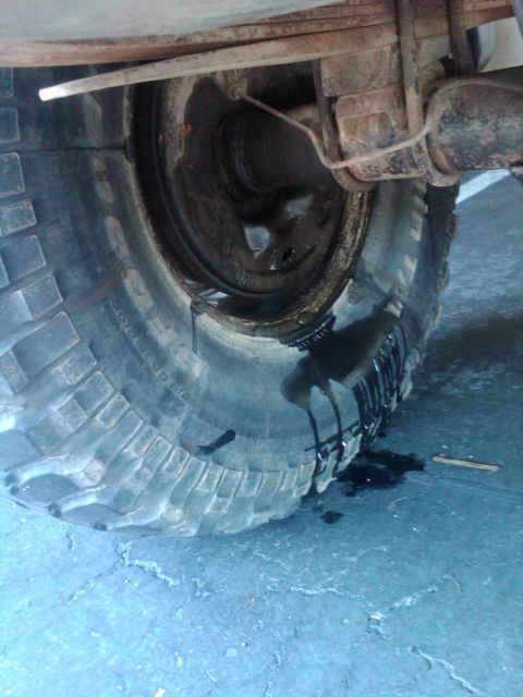 1982 Ford Bronco - Leaking fluid drips from the rear tire and suspension assembly.